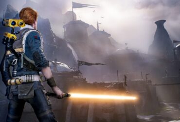 Główny bohater Star Wars Jedi: Survivor stoi przed mroczną lokacją w grze trzymając miecz świetlny.