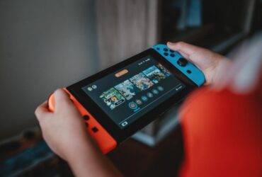 Gracz korzystający z konsoli Nintendo Switch w trybie handheld