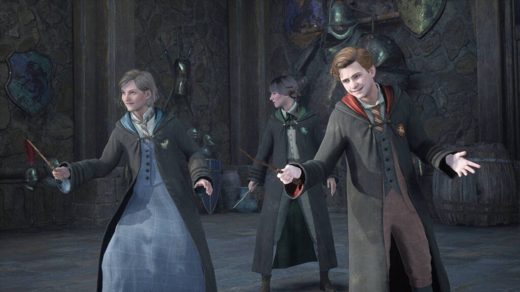 Trzech młodych czarodziejów ćwiczy magię w szkole Hogwart