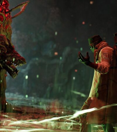 Gracz w Remnant 2 walczący z dużym potworem w jaskini