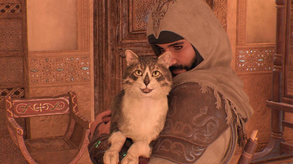 Kot z emblematem Asasynów na rękach Basima