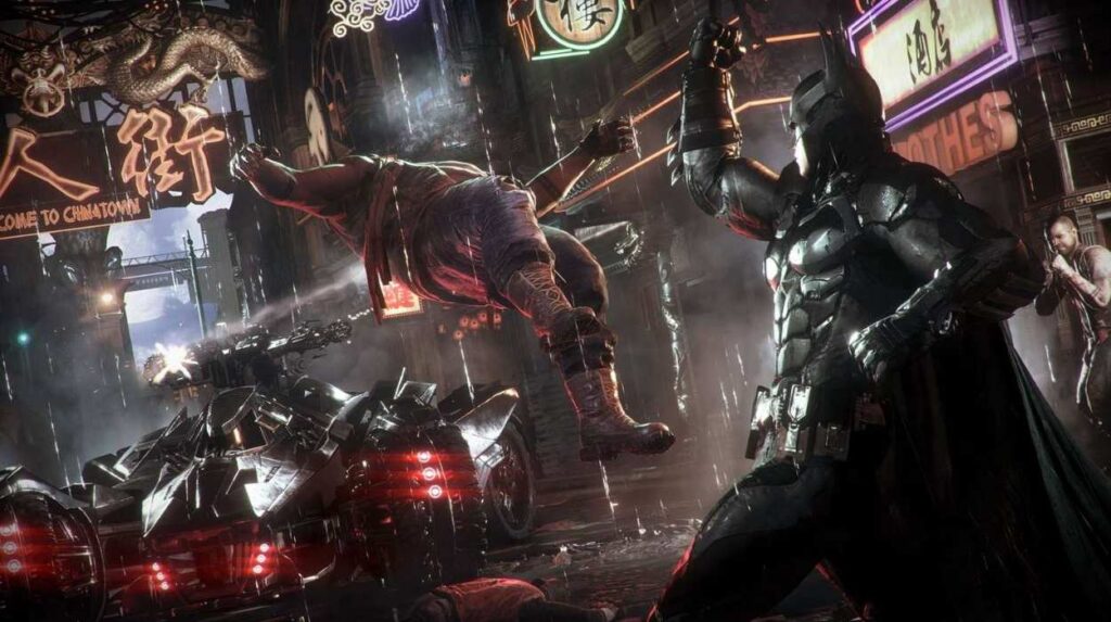 Batman uderzający bandytę na ulicy Gotham City w grze Batman: Arkham Knight